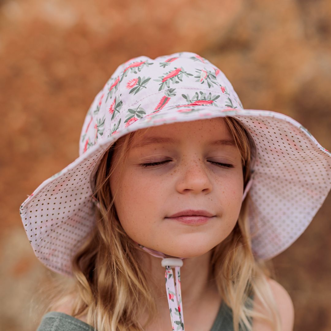 Front view of Banksia Sun Hat on girl with toggle