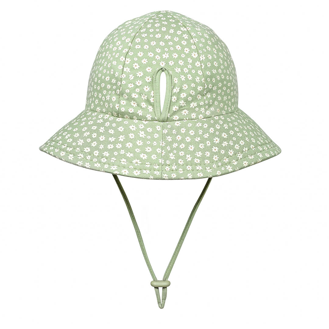 Bedhead Hats Grace sun hat for girls with white daisies on green background with ponytail slit