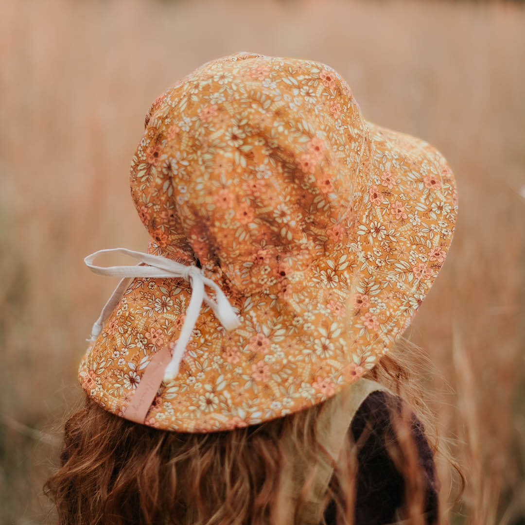Back view of Bedhead Hats Heritage Alice print with a floral design on an orange background