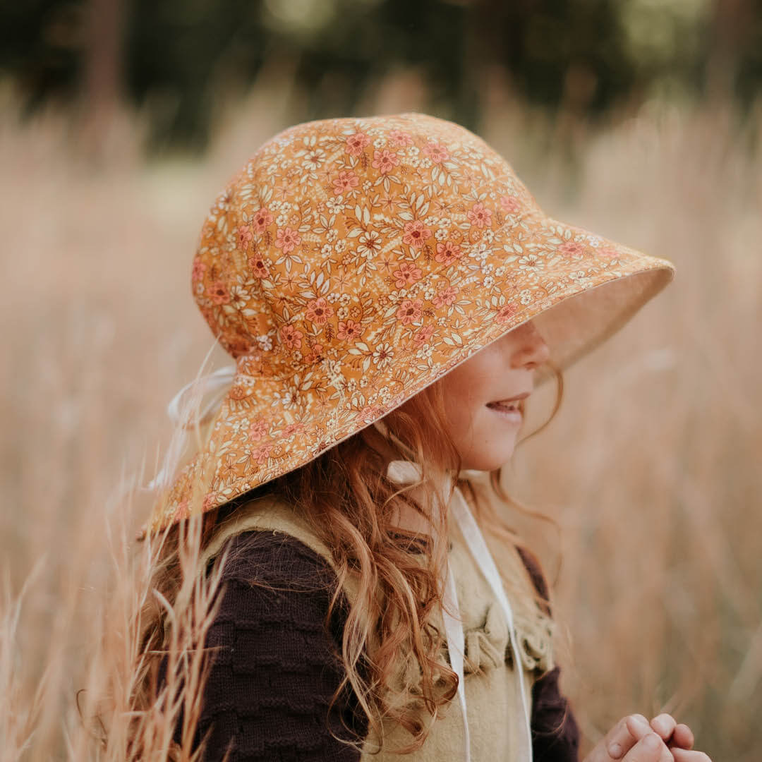 Side view of Bedhead Hats Heritage reversible sun hat on a young girl.